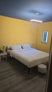a large bed in a room with a yellow wall at Seravale in Serravalle