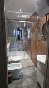 a bathroom with a shower and a toilet and a sink at Seravale in Serravalle