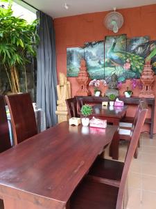 a dining room with a wooden table and chairs at Umah kampung8 in Mataram