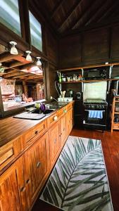 a kitchen with a sink and a stove top oven at TAHITI - PK18 Beach Cottage in Punaauia