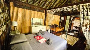a bedroom with a bed and a chair in a room at TAHITI - PK18 Beach Cottage in Punaauia