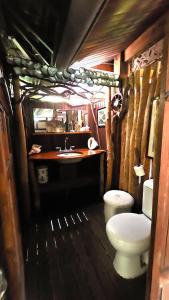 a bathroom with a toilet and a sink at TAHITI - PK18 Beach Cottage in Punaauia