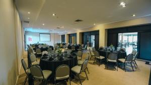 a conference room with tables and chairs and a screen at Hathor Concordia in Concordia +51 photos