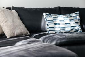 a black couch with two pillows on it at Brilliant 2BD condo in Los Angeles