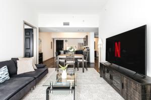 a living room with a large flat screen tv at Brilliant 2BD condo in Los Angeles