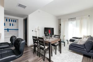 a living room with a dining room table and chairs at Brilliant 2BD condo in Los Angeles