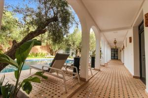 an outdoor corridor of a house with a swimming pool at Dariana guesthouse in Marrakesh