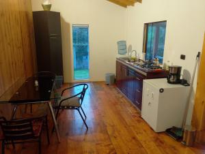 a kitchen with a table and a dining room at Cabaña Ortiz in Guatavita