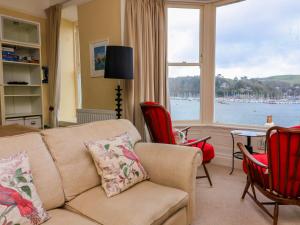 a living room with a couch and chairs and a large window at 3 Dartview in Dartmouth
