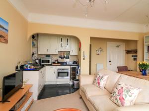 a living room with a couch and a kitchen at 3 Dartview in Dartmouth +19 photos