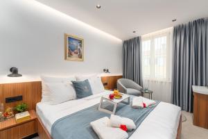 a hotel room with a bed and a table at Arriba Rooms in Poreč +38 photos