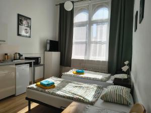 two beds in a room with a window at U Szermierzy in Wrocław