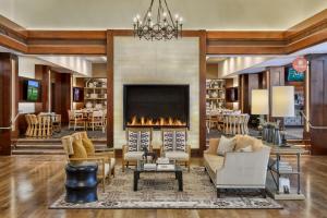 a living room with a fireplace and chairs and a table at Omni La Costa Resort & Spa Carlsbad in Carlsbad