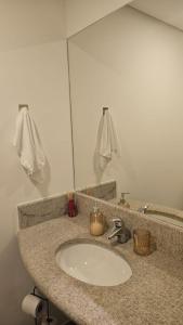 a bathroom counter with a sink and a mirror at Studio 4 - São Caetano proximo GM in São Caetano do Sul