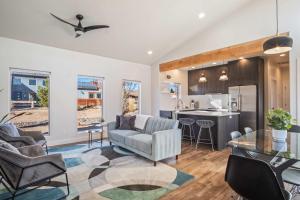 a living room and kitchen with a couch and a table at Timber & Tin C 2Bed 2Bath w Pool & Rooftop Deck in Kanab
