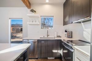 a kitchen with stainless steel appliances and a window at Timber & Tin C 2Bed 2Bath w Pool & Rooftop Deck in Kanab