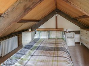 a bedroom with a bed in a attic at Glanyrafon Smithy in Llandysul