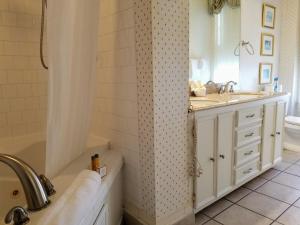 a bathroom with a tub and a sink and a shower at The Queen Anne Bed & Breakfast in Natchitoches +56 photos