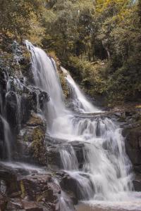 a waterfall on the side of a rocky river at Moconá Virgin Lodge in Moconá Falls +6 photos