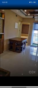 a room with a wooden table in a room at D D Highway gate in Cochin
