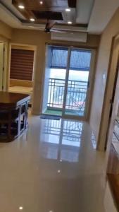 a room with a large glass door with a balcony at D D Highway gate in Cochin