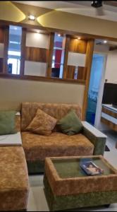 a living room with a couch and a table at D D Highway gate in Cochin
