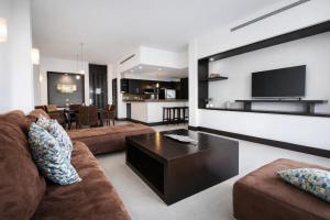 a living room with a couch and a coffee table at Aldea Thai Studios Steps to Beach and 5th Ave in Playa del Carmen