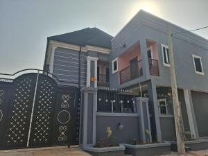 a house with a black gate and the ocean at Knock inn luxury apartment in Benin City