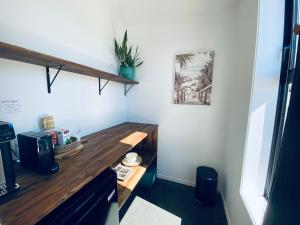 a kitchen with a wooden counter top in a room at The Modern Alpine Oasis - Mountain Views - Rainfall Shower - Perfect for Couples in Wanaka