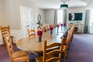 a dining room with a long table and chairs at General Denver Hotel in Wilmington