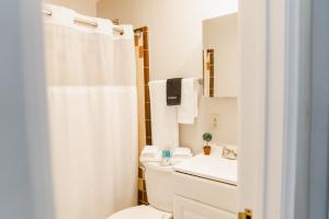 a white bathroom with a toilet and a sink at General Denver Hotel in Wilmington