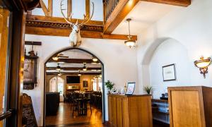 an archway in a restaurant with a deer head on the wall at General Denver Hotel in Wilmington