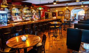a bar with wooden tables and chairs in a restaurant at General Denver Hotel in Wilmington +12 photos