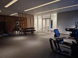 a large room with a gym with a treadmill at Rumah Cluster Springwood1 in Pontianak