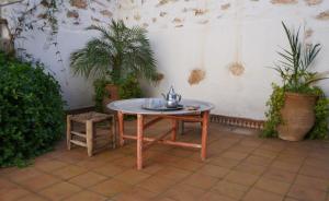 a table with a tea kettle on it in a room with plants at Bergerie Imsouane in Imsouane