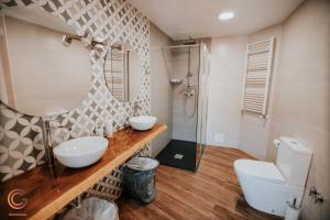 a bathroom with two sinks and a shower at Apartamentos Cañón de la Rinconada in Trujillo +40 photos