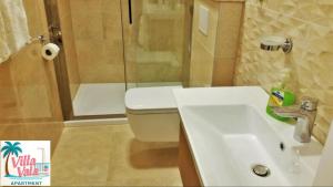a bathroom with a toilet and a sink and a shower at Apartment Villa Vala in Malinska +24 photos