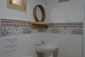 a bathroom with a sink and a mirror on the wall at Bergerie Imsouane in Imsouane