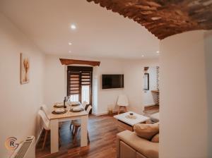 a living room with a table and a couch at Apartamentos Cañón de la Rinconada in Trujillo