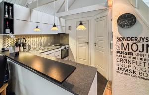a kitchen with a counter and a clock on the wall at 3 Bedroom Cozy Home In Haderslev in Haderslev