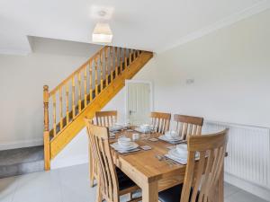 a dining room with a wooden table and chairs at Dawson Park 10 - Uk12669 in Mablethorpe
