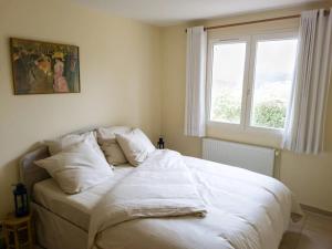 a white bed in a bedroom with a window at Gîte Guillaume with swimming pool in Carcès +21 photos