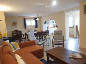 a living room with a couch and a table at Gîte Guillaume with swimming pool in Carcès