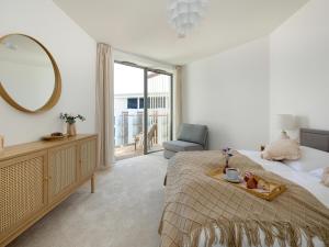 a bedroom with a bed and a mirror and a chair at Large apartment with sea view, indoor pool in Pobierowo +40 photos
