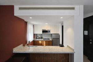 a kitchen with a counter top in a room at Aldea Thai Studios Steps to Beach and 5th Ave in Playa del Carmen