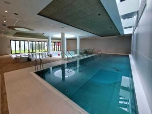 a large swimming pool in a building at Apartment with direct sea view in Pobierowo
