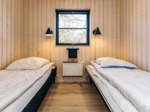 two beds in a room with a window at 8 person holiday home in Vig in Vig