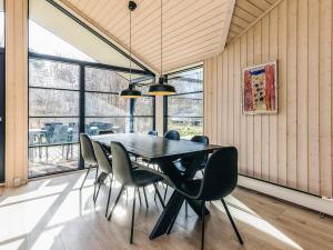 a dining room with a black table and chairs at 8 person holiday home in Vig in Vig