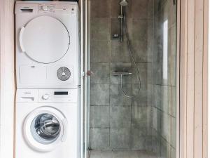 a washing machine in a bathroom with a shower at 8 person holiday home in Vig in Vig +20 photos