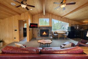 a living room with a couch and a fireplace at Riverside Loft Suite home in Leavenworth